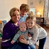 Happy family posing with baby in living room