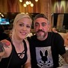 Couple smiling for a photo with a man wearing a black bunny t-shirt